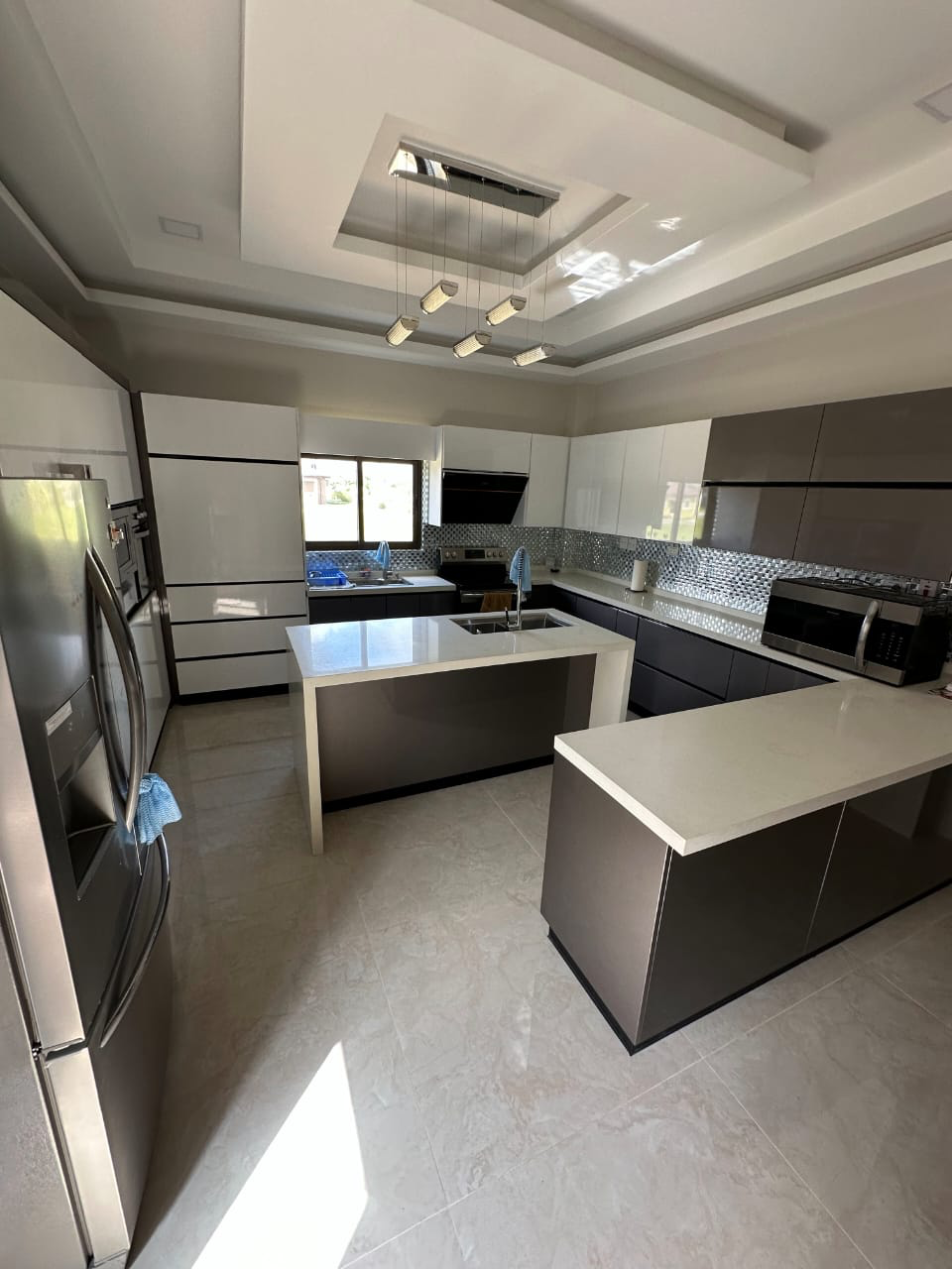 Contemporary kitchen with island inside the Ella Vista Gardens residence